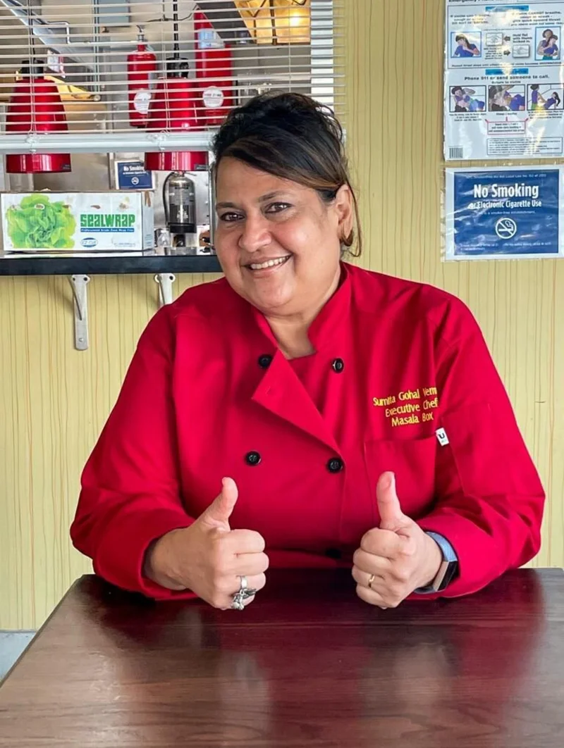 Chef Sumita Gohal-Verma in her red Masala Box chef coat